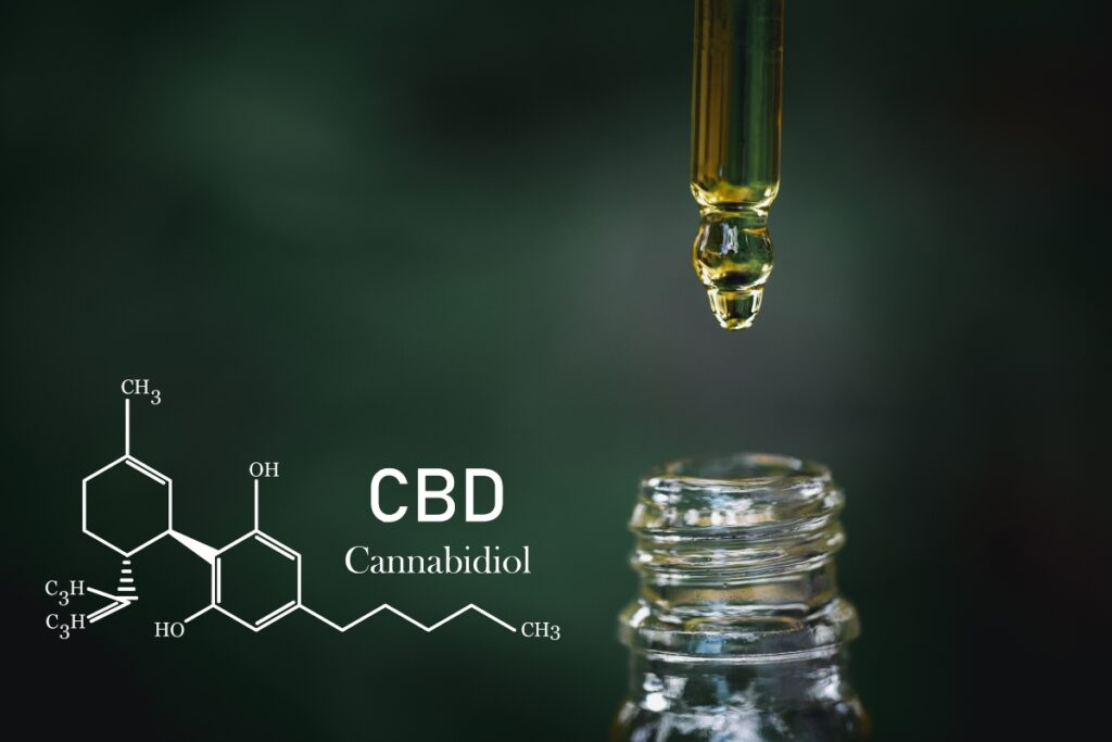 A drop of CBD oil on a green background, perfect for athletes.