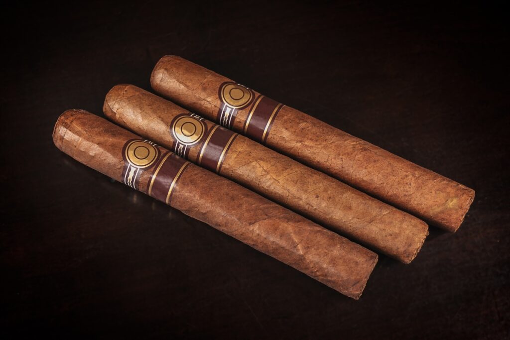 Three cigar gift ideas on a dark background.