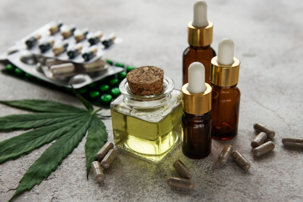 A collection of bottles containing liquid, pills, and CBD for potential health benefits.
