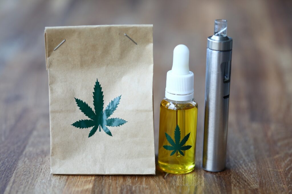 A paper bag with a cbd oil bottle next to it, showcasing one of the best cbd vapes.
