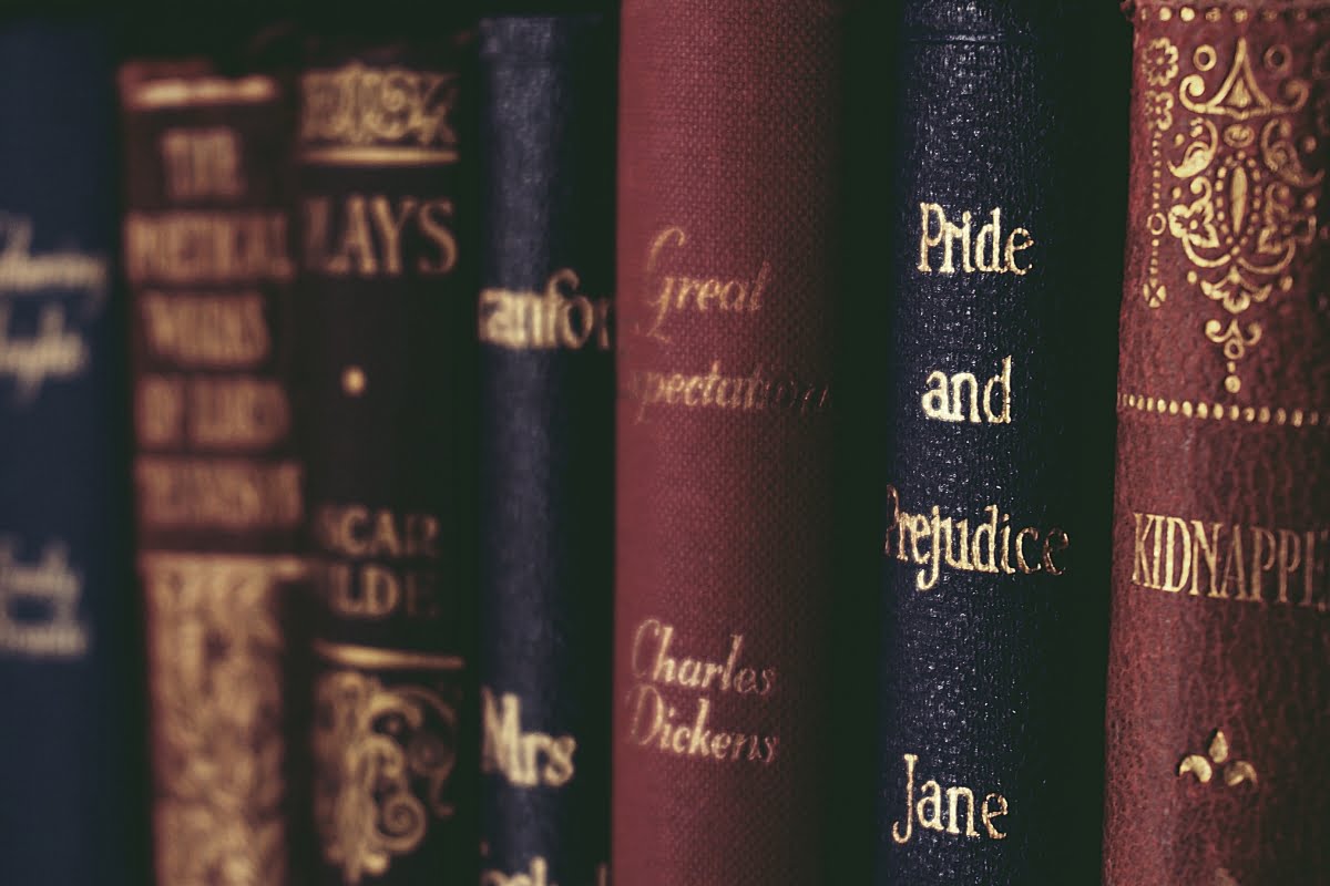 A close-up of classic books on a shelf, including titles such as "Pride and Prejudice," "Great Expectations," "Selected Plays," and "The Works of Lord Byron," invites a cozy escape akin to the calm after a smoking session.